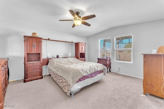 bedroom with ceiling fan, light carpet, and vaulted ceiling