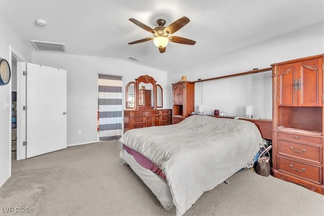 bedroom with ceiling fan, lofted ceiling, and light colored carpet