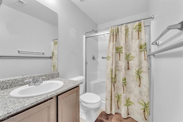 bathroom featuring toilet, vanity, and a shower with curtain