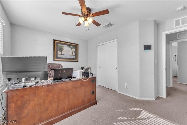 carpeted home office with ceiling fan