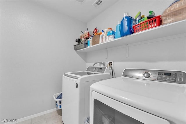 washroom featuring light tile patterned floors and washing machine and dryer