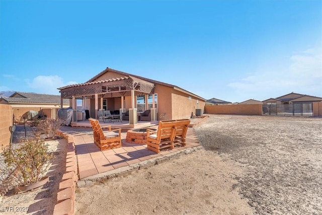 back of property with a pergola, an outdoor fire pit, cooling unit, and a patio