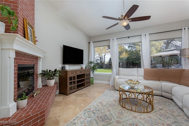 living room featuring ceiling fan, lofted ceiling, and a brick fireplace