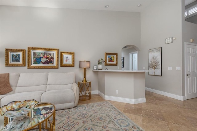 living room featuring a high ceiling