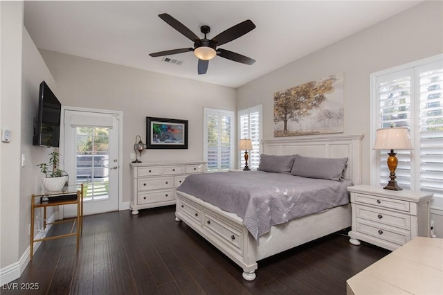 bedroom featuring multiple windows, access to exterior, dark hardwood / wood-style floors, and ceiling fan