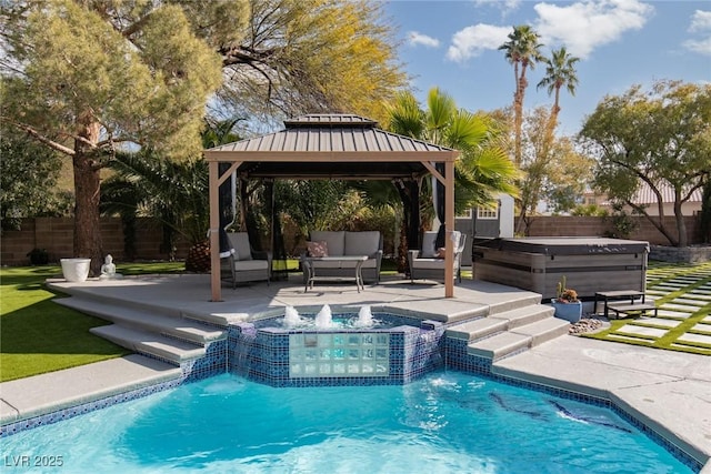 view of swimming pool with a patio, pool water feature, an outdoor hangout area, a hot tub, and a gazebo