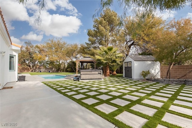 exterior space with a gazebo, a swimming pool with hot tub, and a storage unit