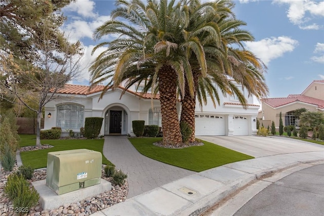 mediterranean / spanish-style home with a front yard