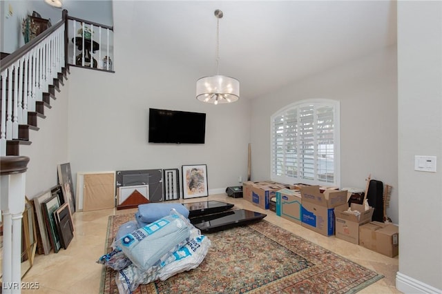 living room featuring light tile patterned floors and an inviting chandelier