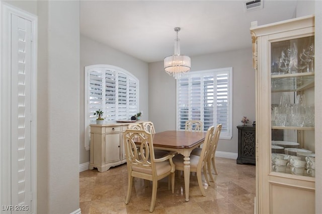 dining space with a chandelier