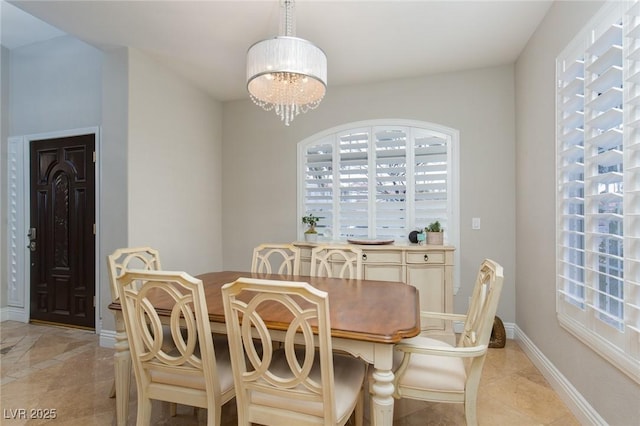 dining space featuring an inviting chandelier