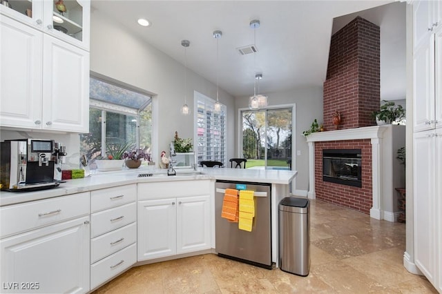 kitchen with pendant lighting, sink, dishwasher, white cabinetry, and kitchen peninsula