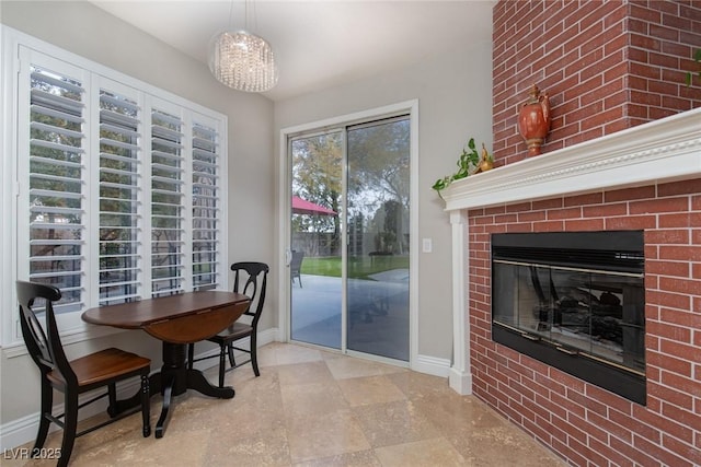 dining area featuring a fireplace and plenty of natural light