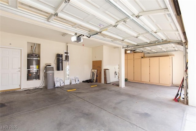 garage featuring a garage door opener and strapped water heater