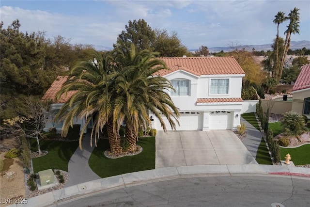 mediterranean / spanish house with a garage