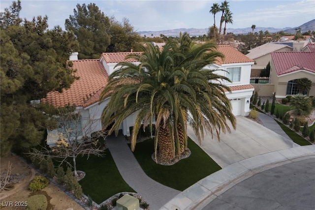 exterior space featuring a garage and a mountain view