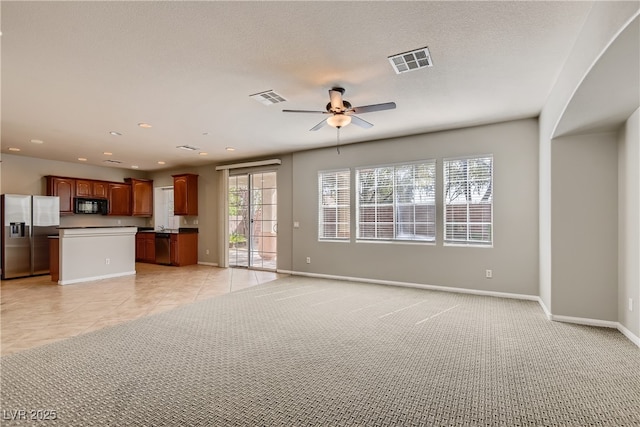 unfurnished living room with ceiling fan and light tile patterned floors