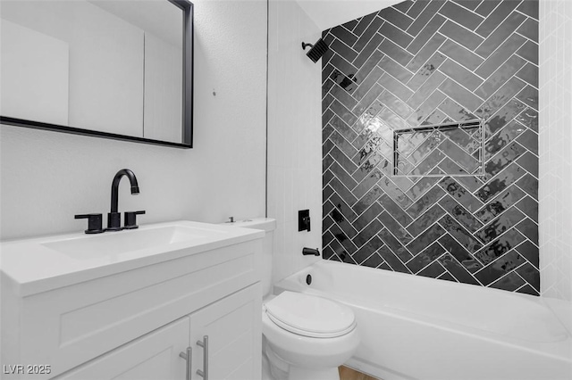 full bathroom featuring toilet, tiled shower / bath combo, and vanity