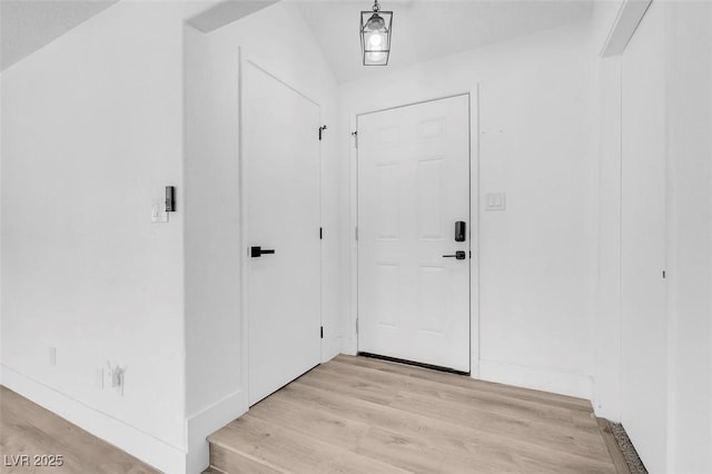 entryway featuring light hardwood / wood-style flooring and lofted ceiling