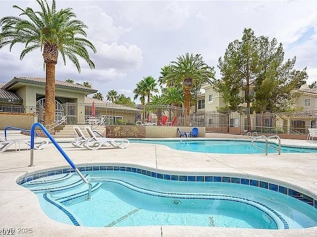 view of swimming pool with a community hot tub