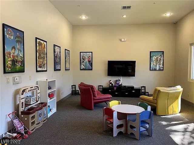 rec room with dark colored carpet