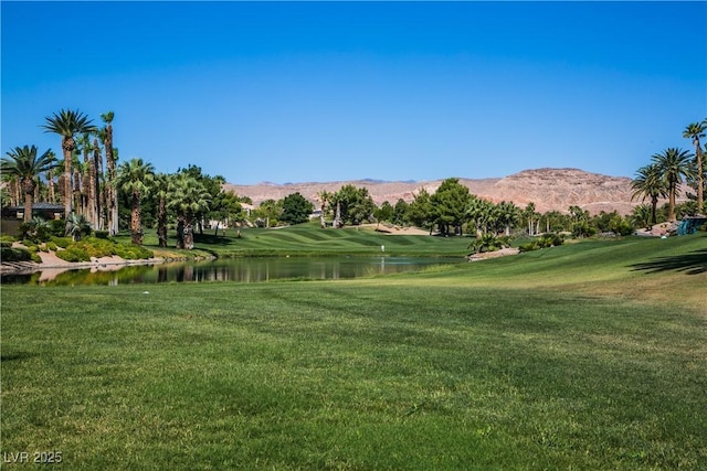 view of community featuring a lawn and a water and mountain view