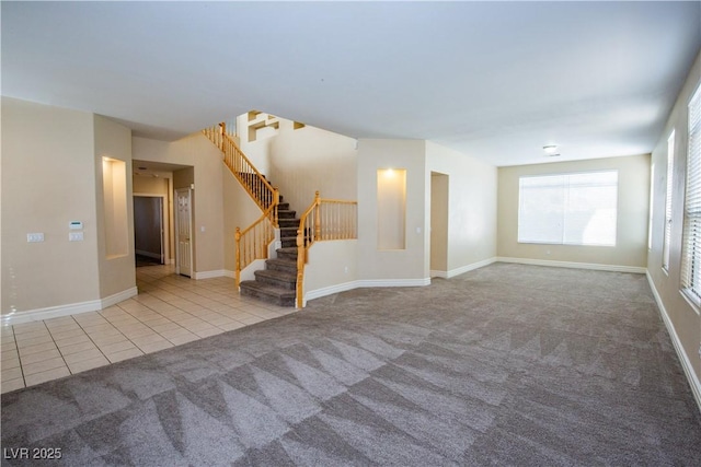 unfurnished living room featuring light carpet