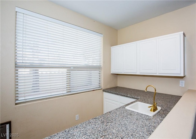 kitchen with sink and white cabinetry