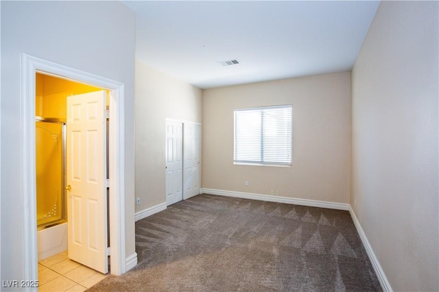 unfurnished bedroom featuring a closet and light carpet