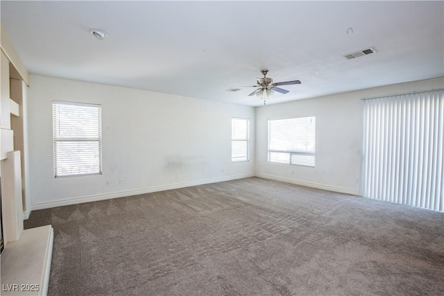 carpeted spare room with ceiling fan