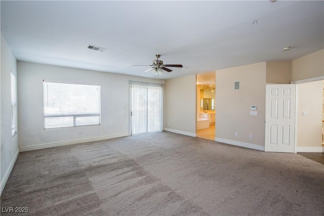 unfurnished living room featuring ceiling fan and carpet