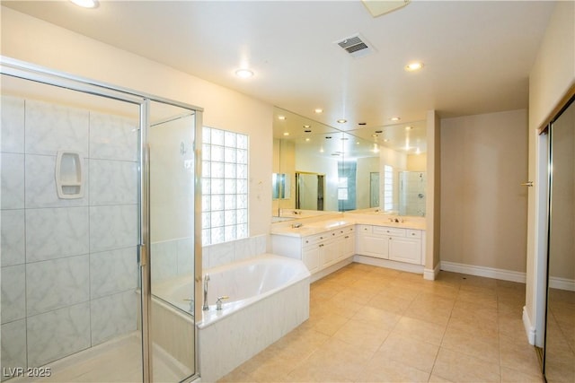 bathroom featuring vanity, tile patterned flooring, and plus walk in shower