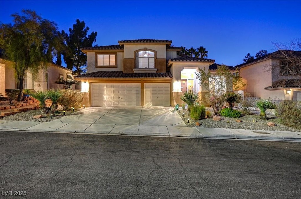 mediterranean / spanish house featuring a garage