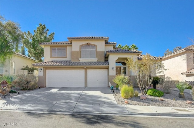 mediterranean / spanish-style house with a garage