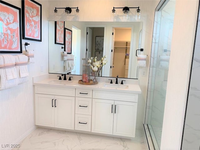 bathroom with a shower with door and vanity