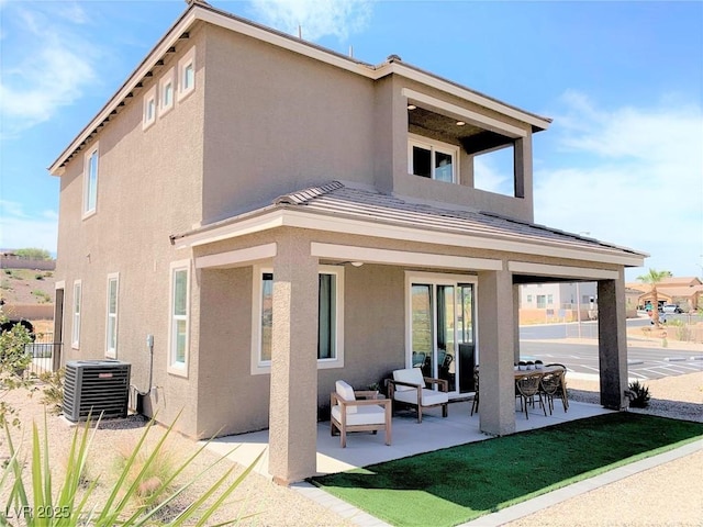 rear view of property with central AC and a patio