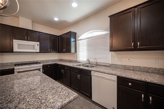 kitchen featuring white appliances, recessed lighting, a sink, tile patterned flooring, and dark brown cabinetry