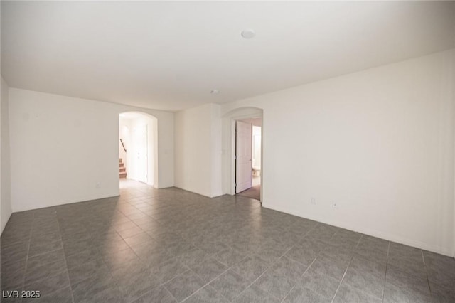 empty room with arched walkways and stairs