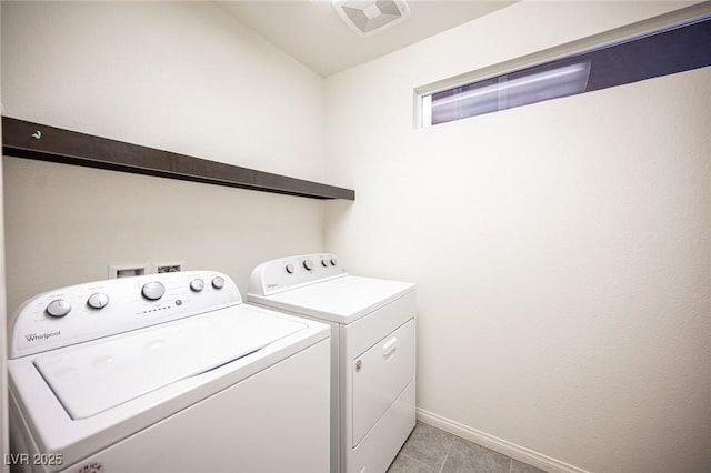 laundry area with washing machine and clothes dryer, visible vents, baseboards, laundry area, and light tile patterned flooring