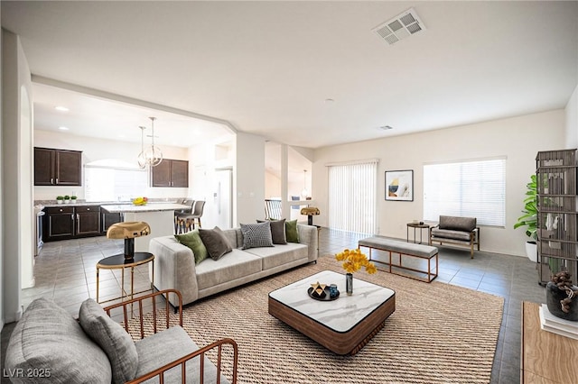 living area with visible vents and light tile patterned flooring