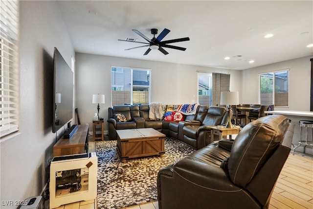 living room featuring ceiling fan and light hardwood / wood-style flooring