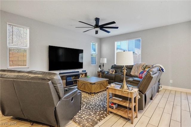 living room with ceiling fan and light hardwood / wood-style floors