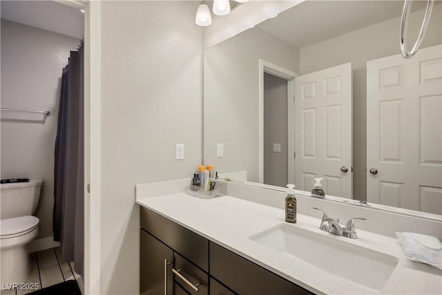 bathroom with tile patterned floors, toilet, and vanity