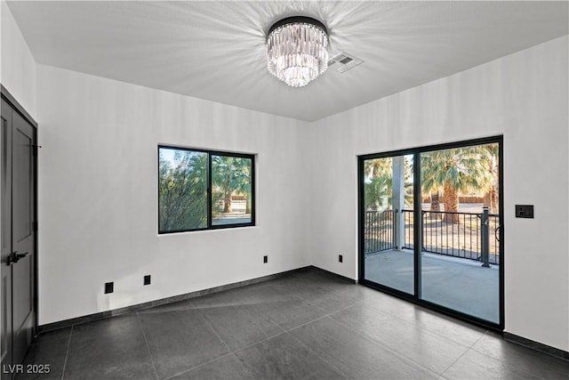 spare room with an inviting chandelier