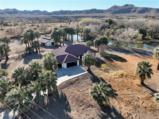 birds eye view of property featuring a water and mountain view