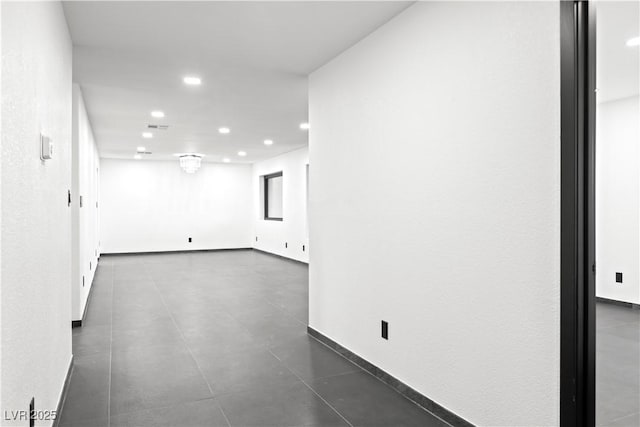 empty room featuring dark tile patterned floors