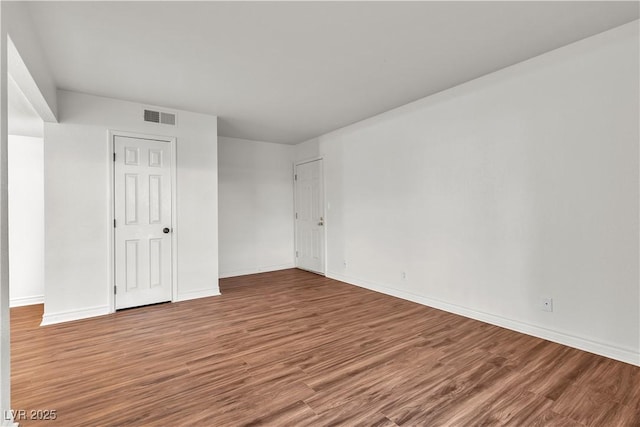 spare room featuring hardwood / wood-style floors