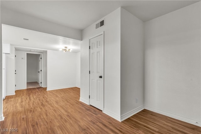 spare room with hardwood / wood-style floors