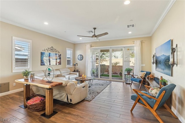 living room featuring ceiling fan, wood-type flooring, and crown molding