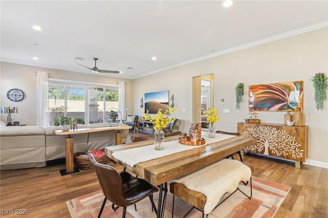 dining area with ceiling fan, light wood-type flooring, and crown molding